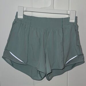 Green Lulu Lemon Athletic Shorts with Reflective Trim and Elastic Waistband
